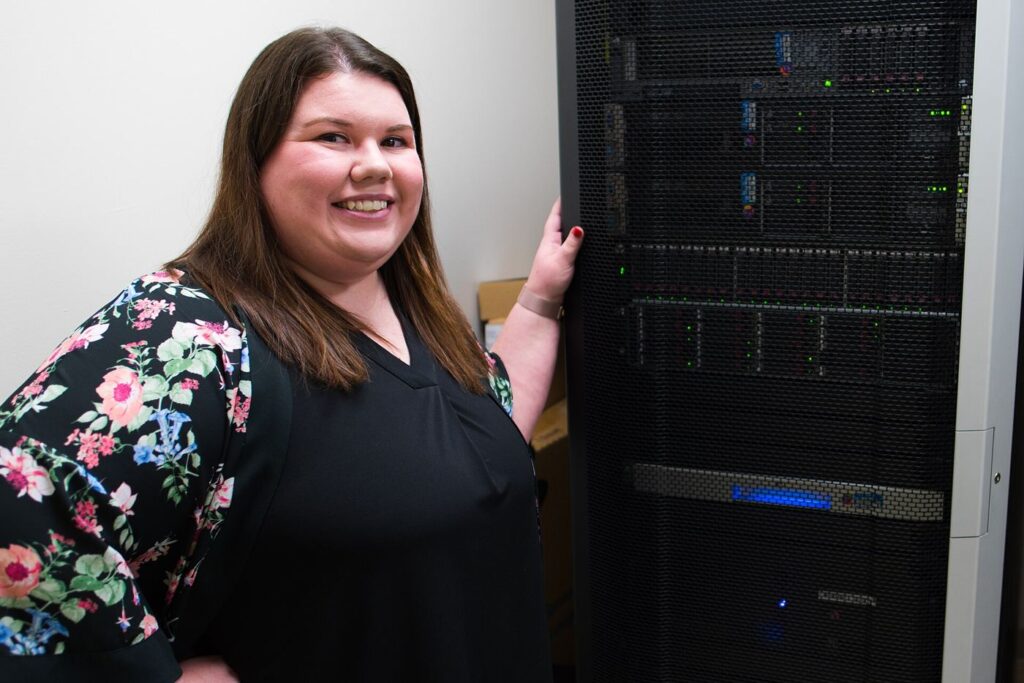 A cybersecurity analyst monitoring screens in an office