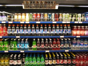 Supermarket shelf with packaged foods and nutrition labels being checked